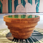 Sottobosco - PEFC-certified wooden coffee table with lichens. In the background, a work by Sea Creative underway for Milan Design Week 2024.